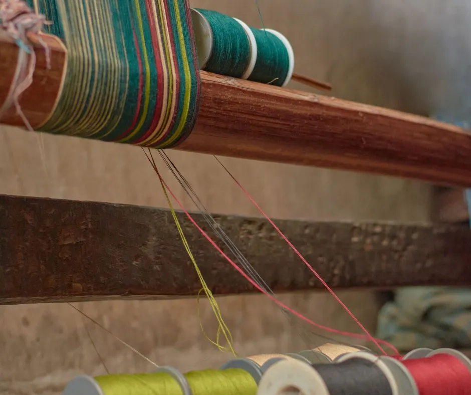 Colorful Yarn carefully arranged on a loom to create authentic aso oke fabric. Photo courtesy of woven market africa