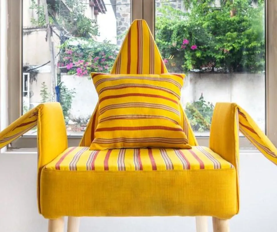 Beautiful yellow chair made with Aso Oke to show the modern use of Aso Oke in fashion