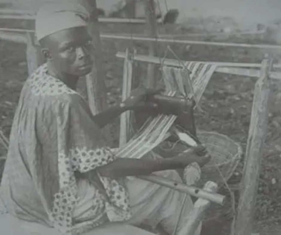 Image of a male aso oke weaver in the 19th Century using a horizontal double heddle loom, one of the earliest known photos of aso oke production.