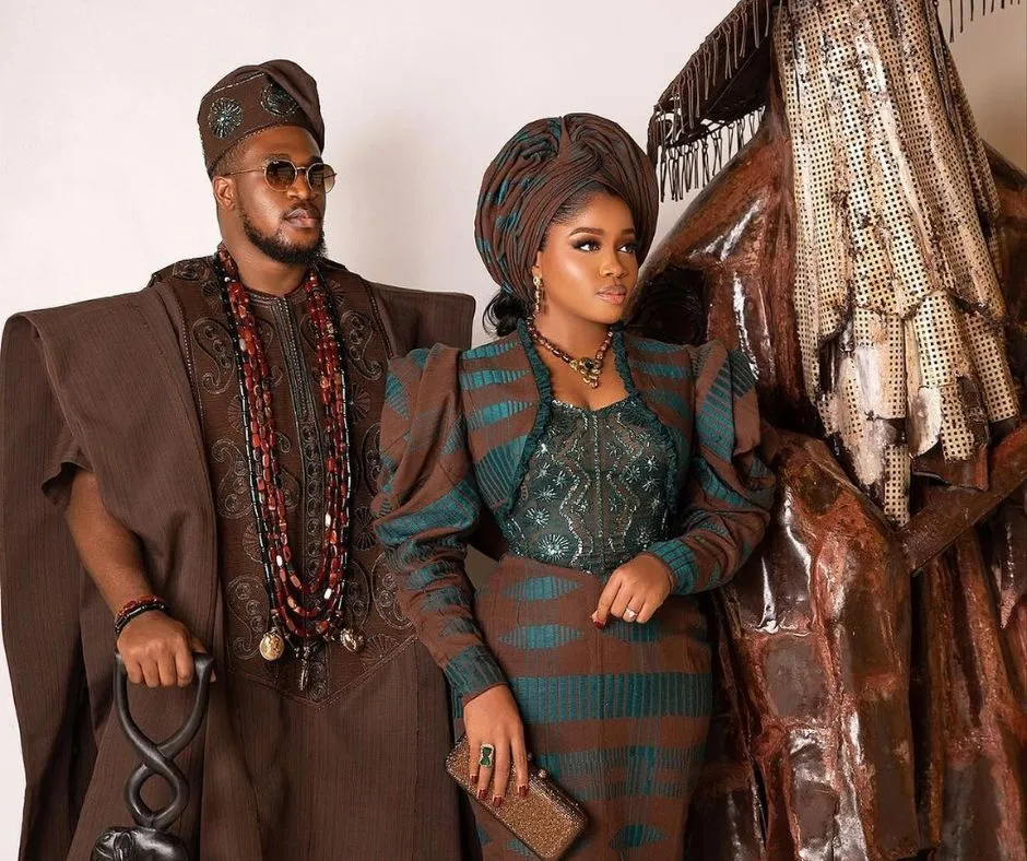 veekee jamea and her husband in matching wedding aso oke. he's wearing a brown agbada while she's in a vintage inspired brown and green aso oke dress