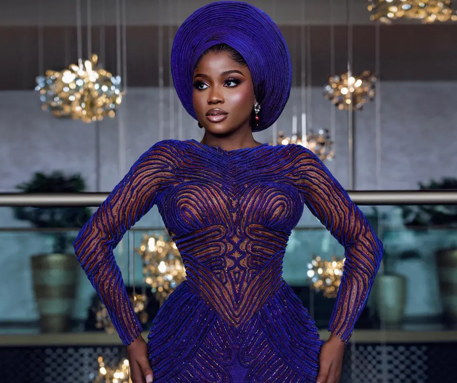 Veekee james in her blue and red duotone metallic aso oke outfit with gele