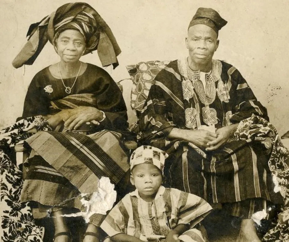 Nigerian couple in the 19th century and their son dressed in aso oke